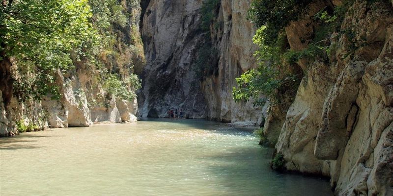 The Acheron river between tall rock walls covered in trees