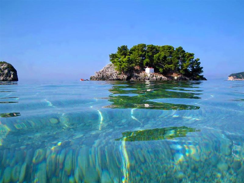 The wooded Panagia islet with its small white chapel